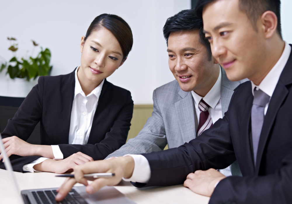 Three business professionals having a positive discussion.